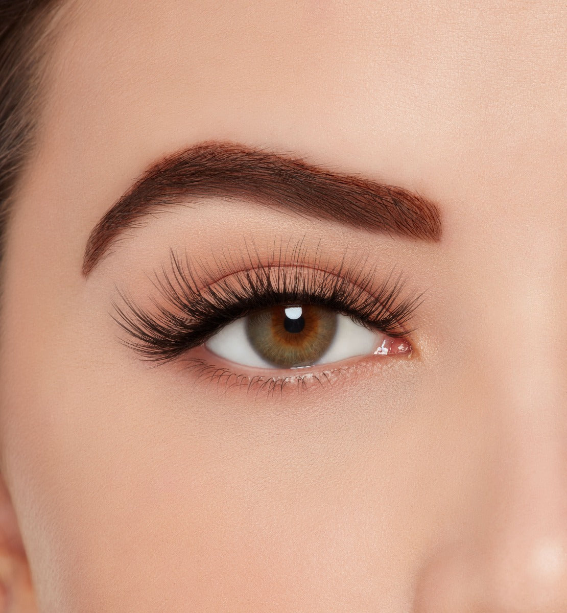 Front view of model with one eye open wearing Ardell 3D Faux Mink 863 to show how they look on the eye