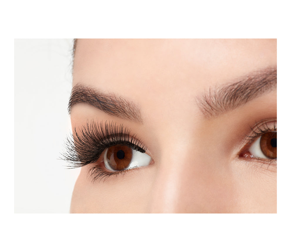 A model wearing Ardell Double Wispies in a side view showing its curly & long length lashes