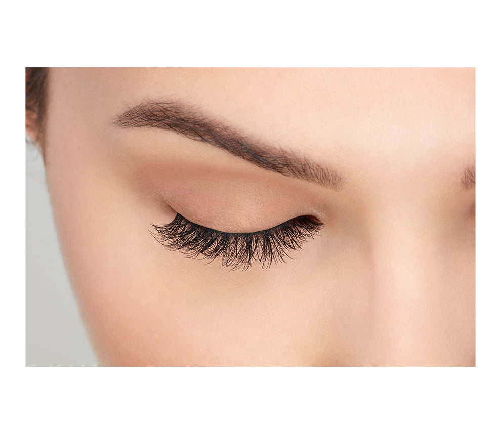 A beautiful woman with a close right eye wearing Ardell Wispies showing how it looks like when it's worn