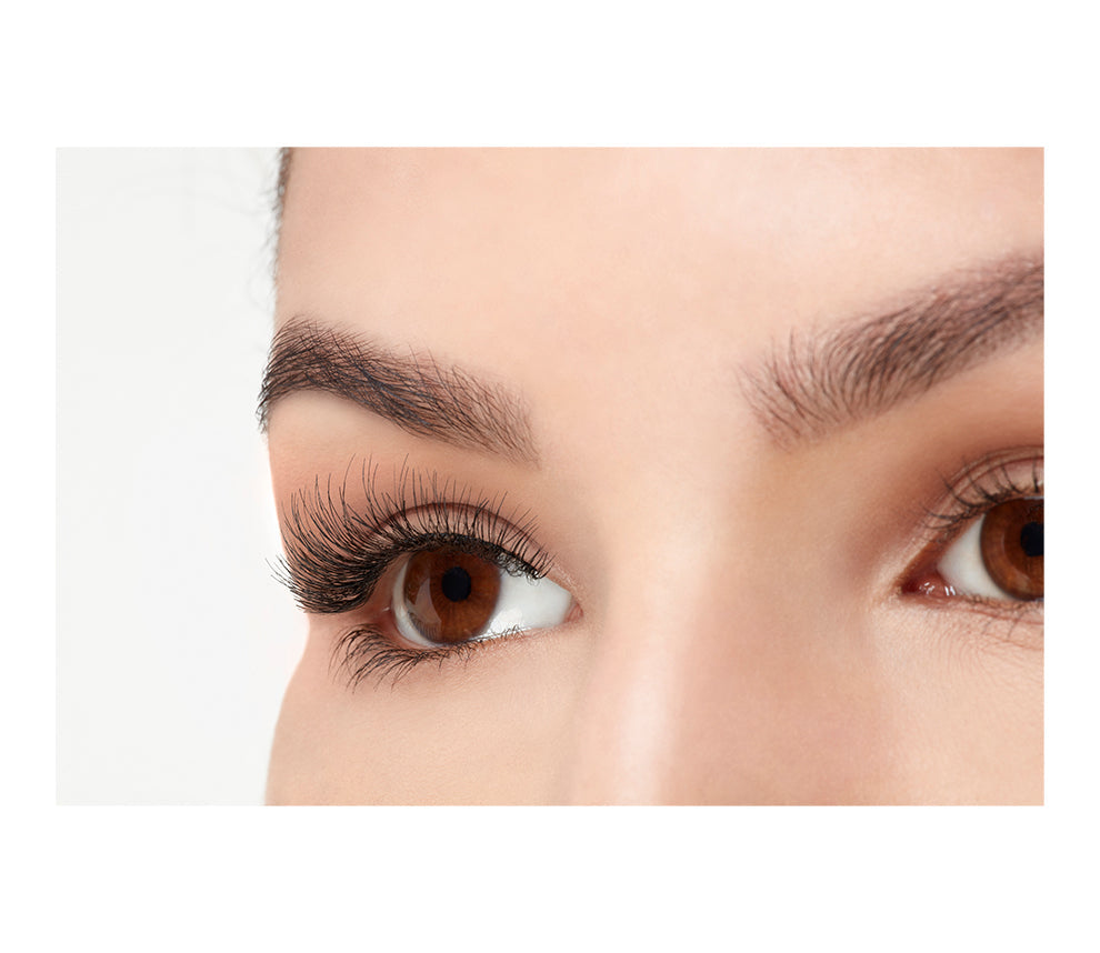 A model with an open right eye wearing Ardell Wispies showing how it looks like when worn in a side view