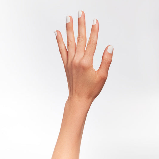 A woman's hand with white nail lacquer.