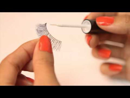 Hands using DUO Brush-On Lash Adhesive applicator for easy lash application.
